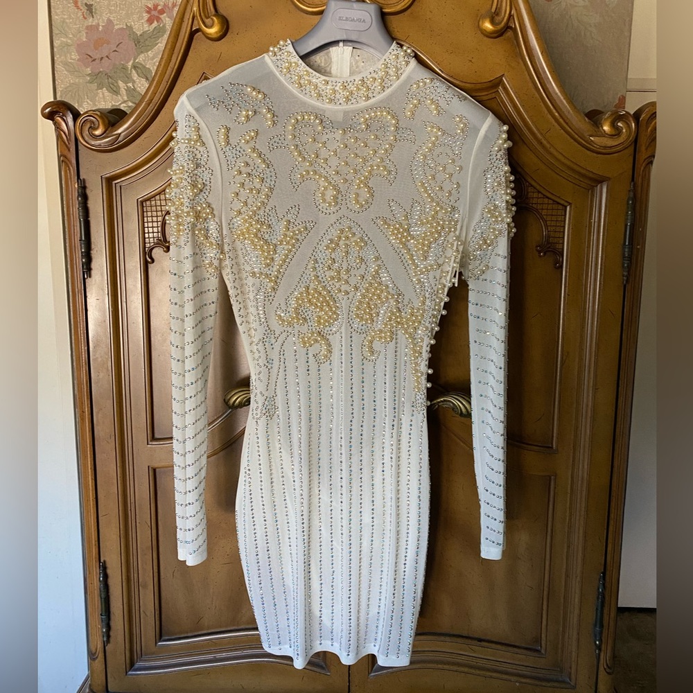 Gorgeous white pearl studded dress with rhinestone jewelry.